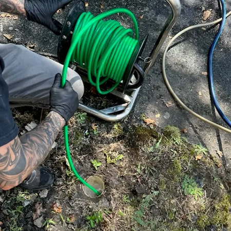 Technicians inspecting a residential main sewer cleanout in charlotte nc
